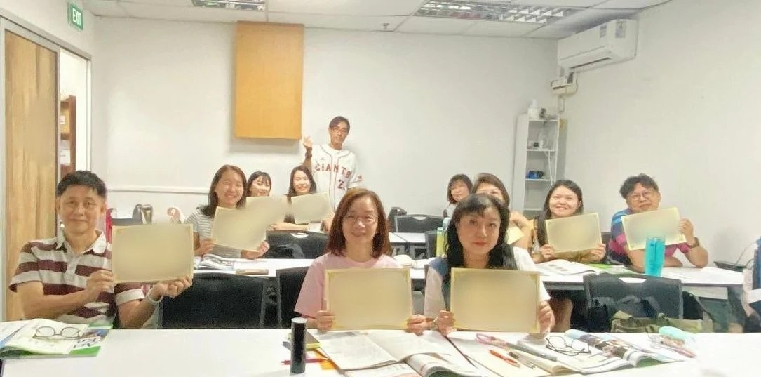 A beginner class with their teacher on completion day