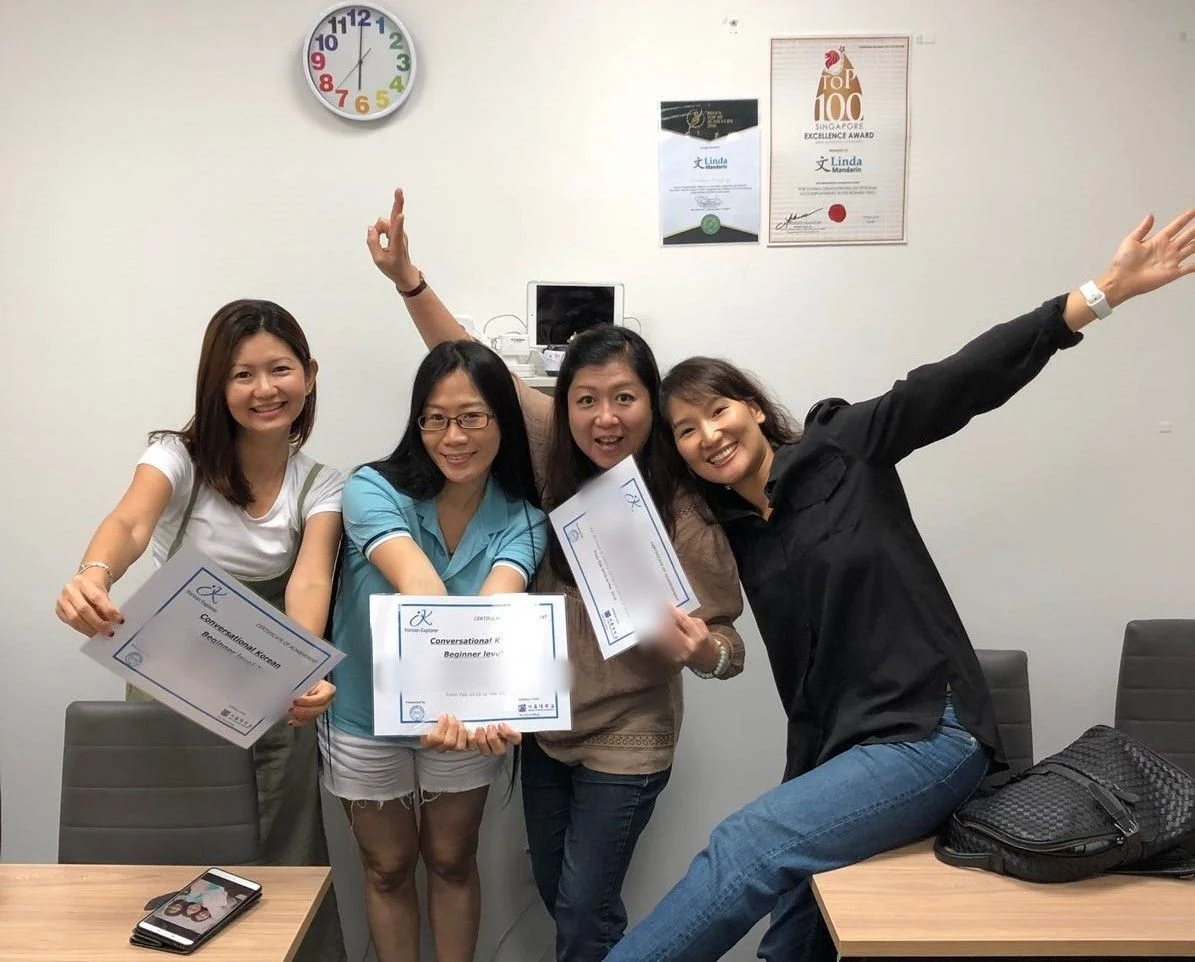 Students celebrating with their Conversational Korean certificates
