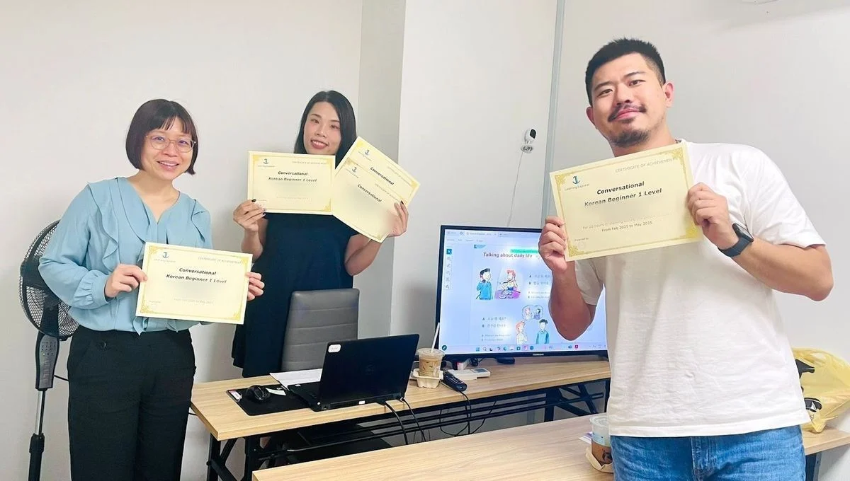 Three students with their Korean Beginner 1 certificates