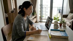 Woman learning Korean via online tutoring at home