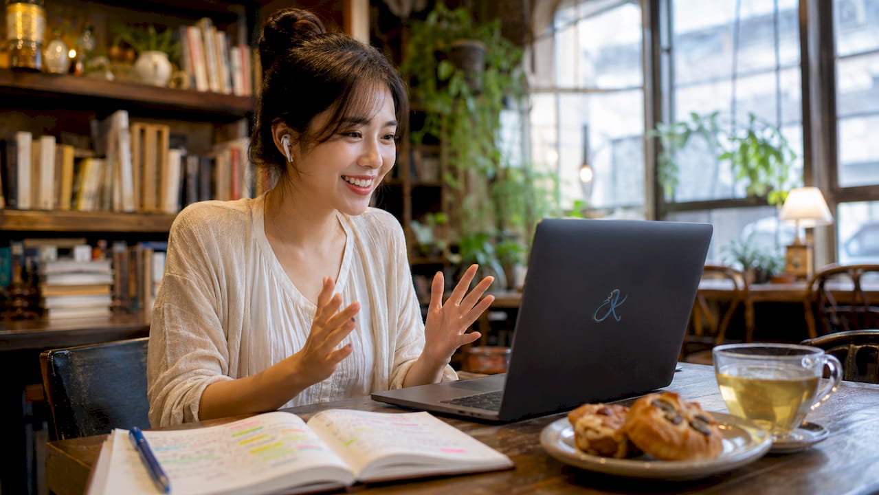 Woman practicing language learning online at cafe