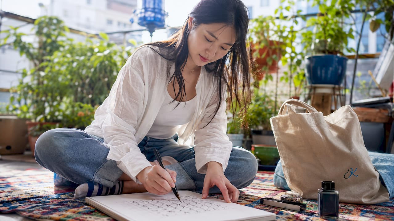 Woman practicing writing Hangul characters