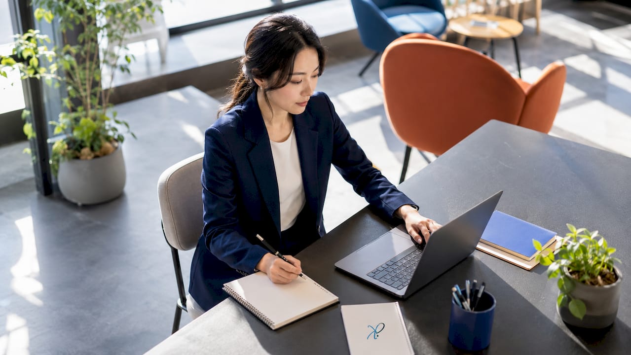 Professional Korean woman in office on video call