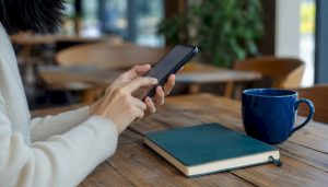 Hand typing Korean slang on smartphone