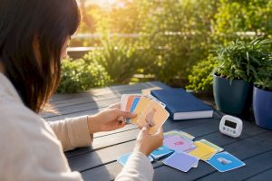 Hands organizing Korean vocabulary flashcards