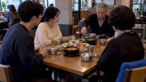 Diners waiting for elder to begin meal