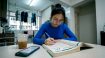 Student studying Korean at kitchen table