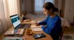 Young woman practicing Korean at home table