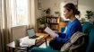 Learner reviewing Korean notes in living room