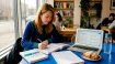 Student studying for Korean exam at kitchen table