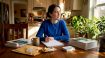 Woman studying for TOPIK exam at kitchen table