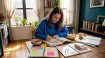 Student studying TOPIK exam materials at kitchen table