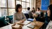 Women discussing Korean conversation in café