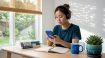 Learner studying Korean dialects with tablet and books