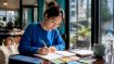 Woman studying Korean numbers at desk