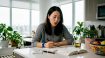 Woman practicing Korean tongue twisters at desk