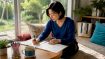 Learner writing Korean characters at city desk