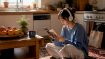 Young woman learning Korean with music at home
