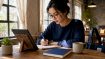 Woman studying Korean with tablet and notebook