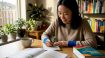 Woman studying Korean language at desk in home office