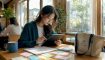 Young woman studying Korean with tablet at desk