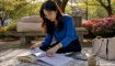 Woman organizing TOPIK exam study materials