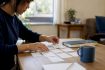 Hands arranging Korean flashcards on desk