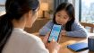 Parent and child checking LifeSG credits