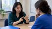 Adult learner practising Korean numbers with instructor